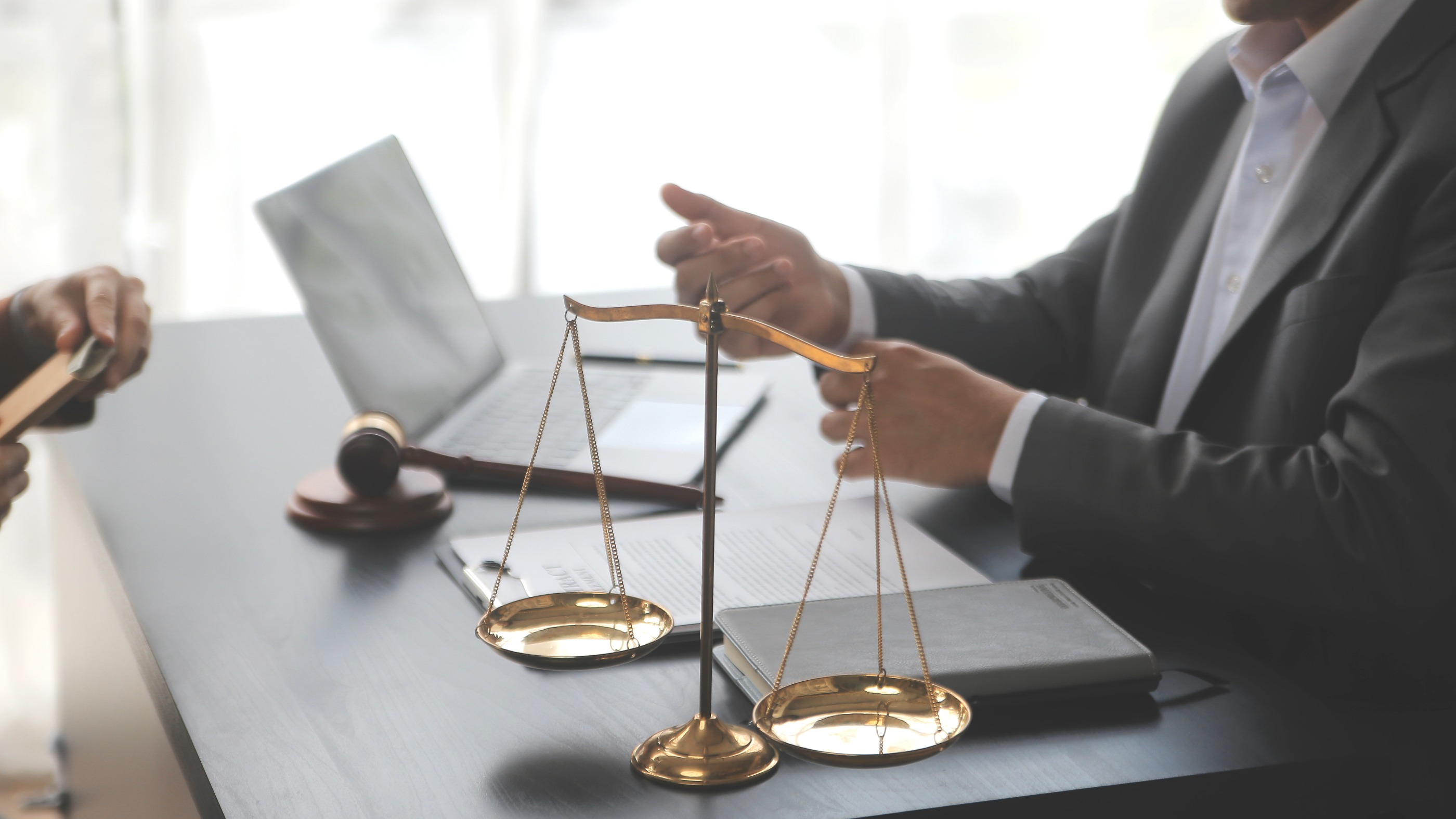 justice-law-conceptmale-judge-courtroom-with-gavel-working-with-computer-docking-keyboard-eyeglasses-table-morning-light